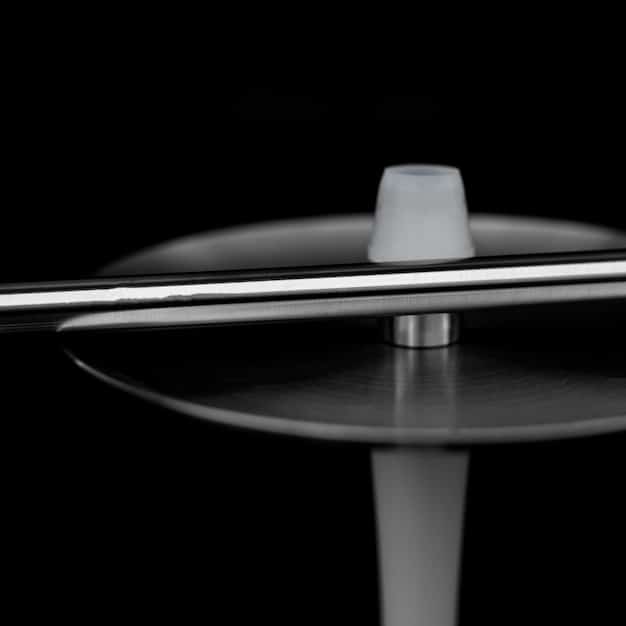 A close-up of vinyl record spinning on a turntable, with a dark, moody lighting highlighting the grooves. The album cover is partially visible, featuring the title 
