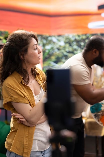 A group of LGBTQ+ filmmakers collaborating on set, discussing a scene with actors, showing the behind-the-scenes diversity and teamwork in filmmaking.