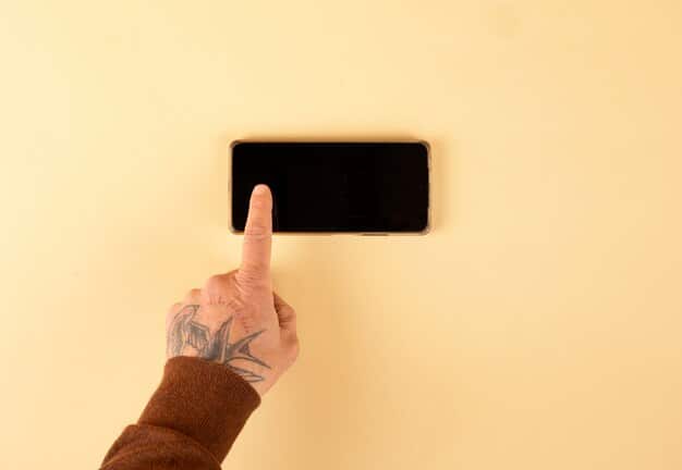 A close-up shot of a hand hovering over a smartphone screen, about to tap on a music streaming app icon. The background is blurred, creating a sense of focus on the user's decision to pay or switch services.