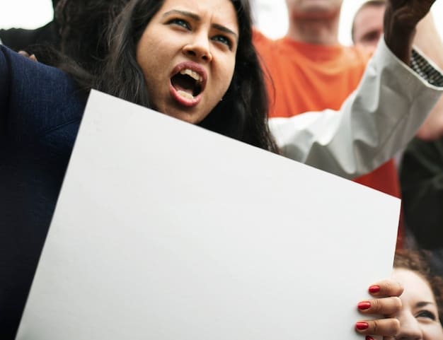 A photo showing a celebrity holding up an advertisement for a brand but also includes people protesting an organization they work with.