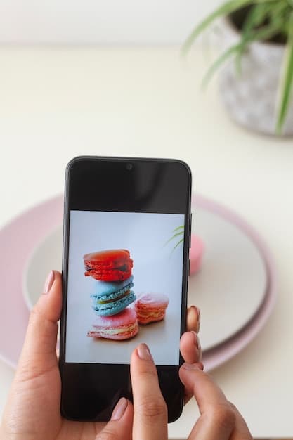A close-up shot of a smartphone screen displaying an Instagram post. The post features a well-known influencer posing with a product, with a caption that includes branded hashtags and a call to action to purchase the product.