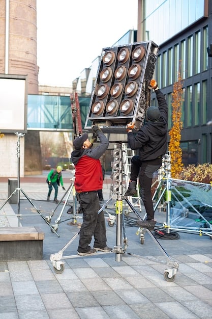 A behind-the-scenes photo of a complex stunt setup, showcasing the safety equipment and the coordination between the stunt team and the film crew.