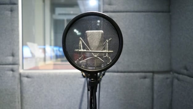 A close-up shot of a microphone with a pop filter, positioned in a home recording studio. The background includes soundproofing panels and recording equipment, symbolizing the increasing accessibility and professionalization of podcast production.