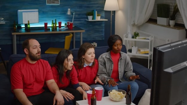 A group of friends lounging on a couch, watching a sitcom on a streaming service, highlighting the accessibility and convenience of modern television viewing habits.