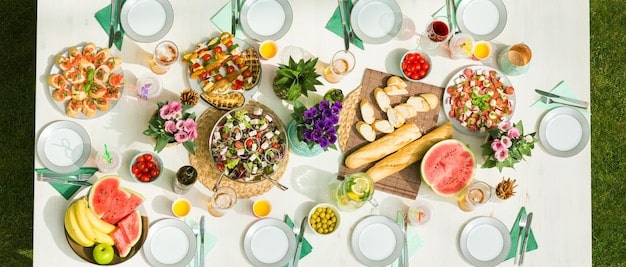 A catering table on a film set with a variety of healthy snacks, bottled water, and fresh fruit laid out meticulously. A label identifies it as 
