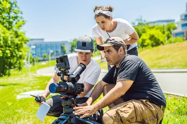 A wide shot capturing a film crew working on an outdoor set during daylight. The focus is on the collaborative effort, with various members engaged in different tasks, showcasing the teamwork involved in film production.