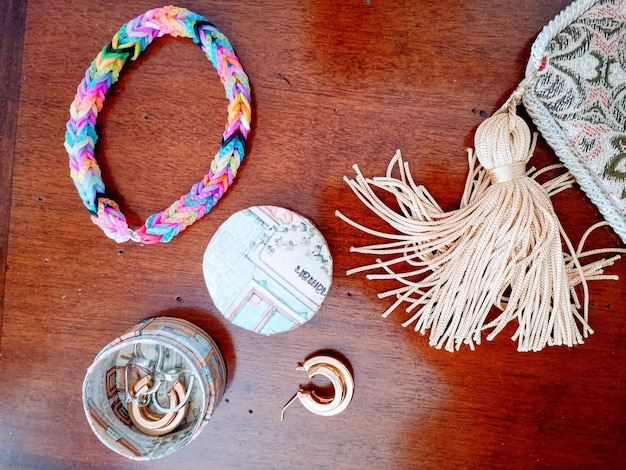 A close up shot of various affordable accessories, including minimalist jewelry (earrings, necklaces, bracelets), a stylish scarf draped over a handbag, and a pair of trendy sunglasses. The accessories should be arranged in an aesthetically pleasing manner, showcasing their affordability and versatility.