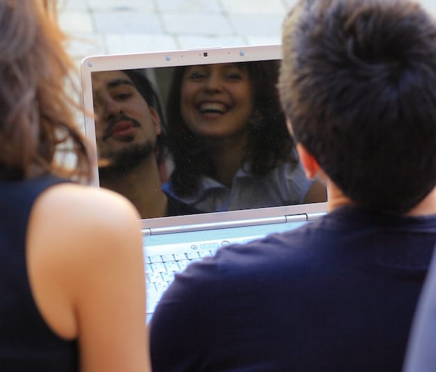 A laptop screen displaying a lively online forum discussion about a recent episode of a popular K-drama. The forum members are using colorful avatars and engaging in enthusiastic debates, showcasing the active online community.