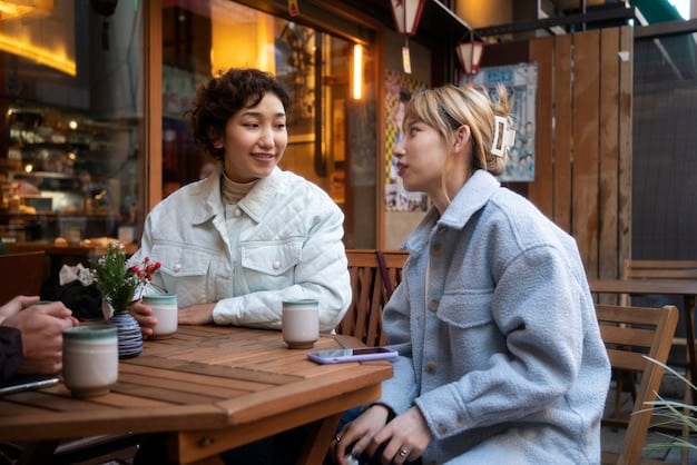 Two young friends, one Korean and one American, sitting at a table in a cafe, studying a Korean phrasebook together. They are both smiling and engaged, surrounded by textbooks and lattes. The atmosphere is bright and friendly.
